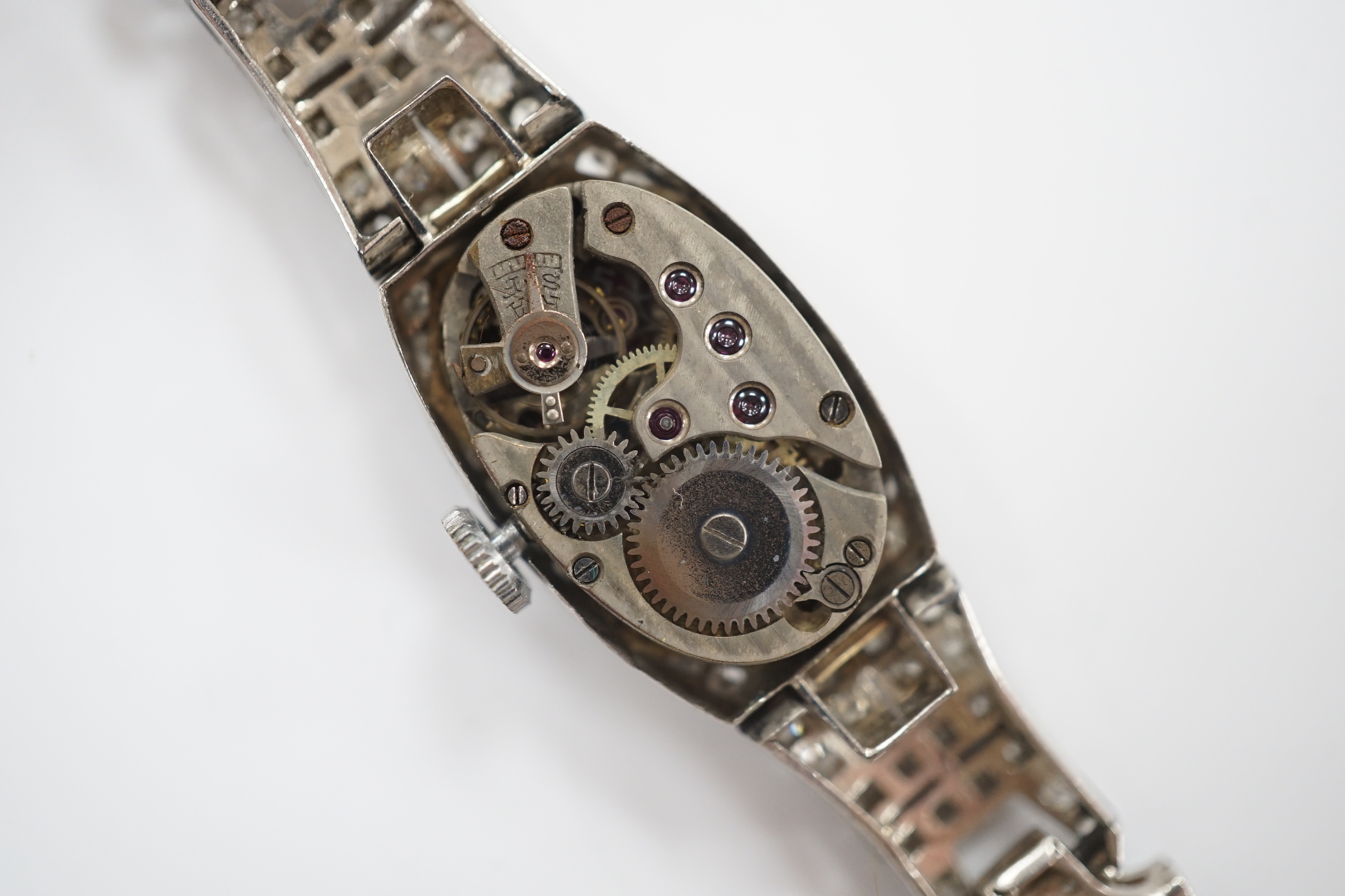 A lady's 1930's/1940's French white metal (platinum mark) and diamond cluster set manual wind cocktail watch, on a twin fabric strap, with metal clasp.